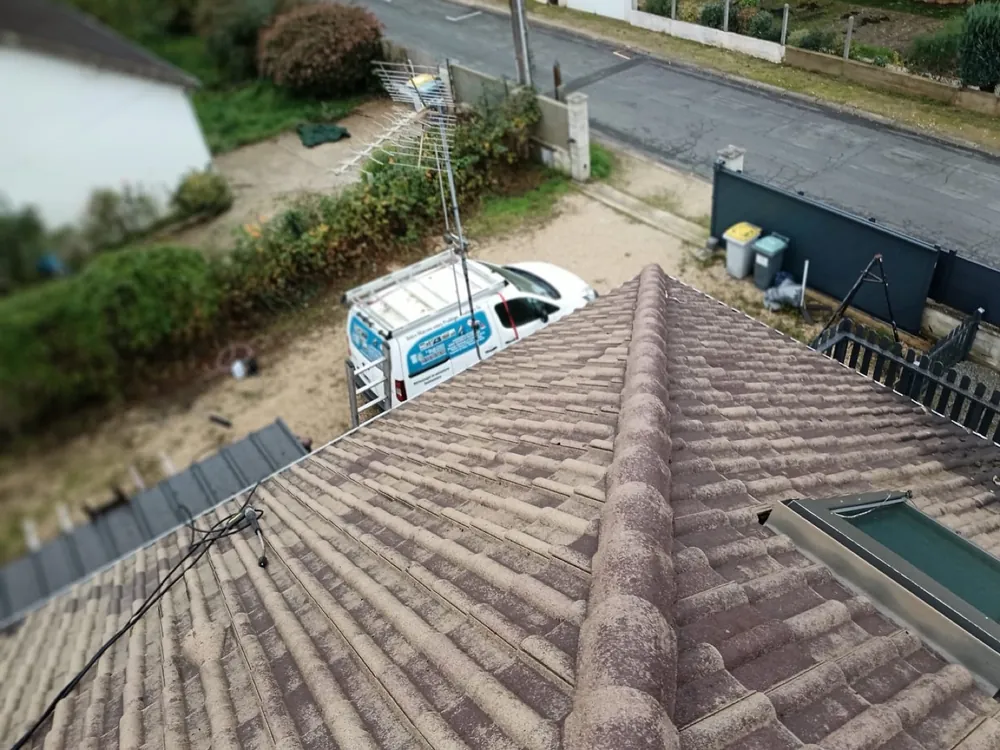 Faîtage de toiture en cours de reprise, camion de chantier au pied de la maison